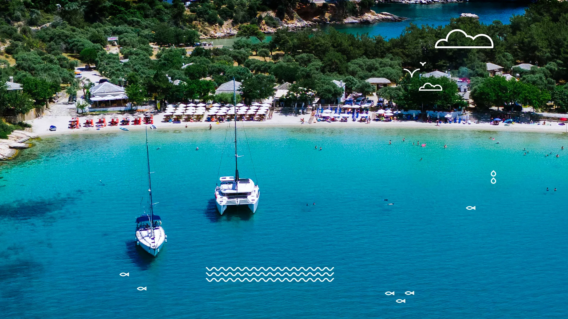 Aerial view of the west bay of Aliki Beach, featuring two white boats and sun umbrellas